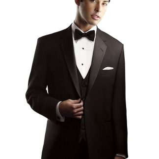 A man in a black tuxedo holds the edge of his notch lapel.