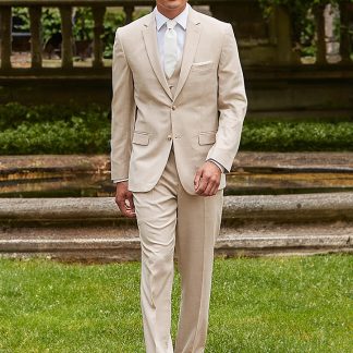 A Man in a Tan sharkskin power stretch suit walks towards the camera in front of a nice estate home