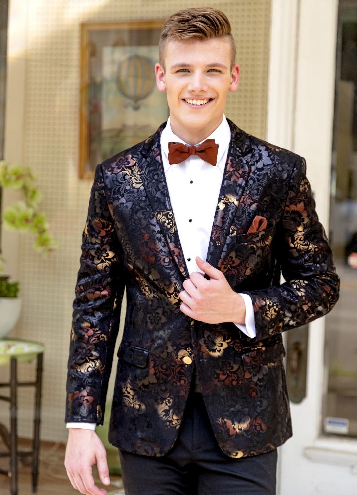 A young man clutches the lapel of his floral metallic 'Ryan' Dinner Jacket